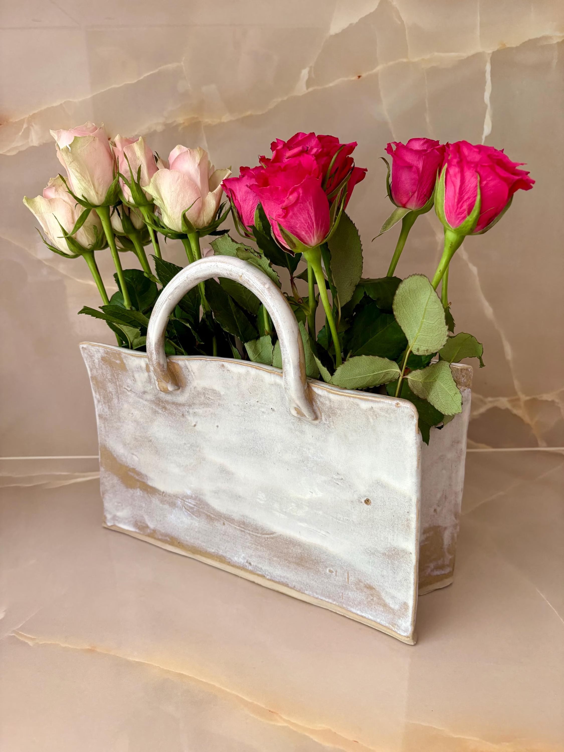 Handmade ceramic Bag Vase by Lusolia, stoneware shaped like a soft tote with gold and bronze glaze pooling along the base